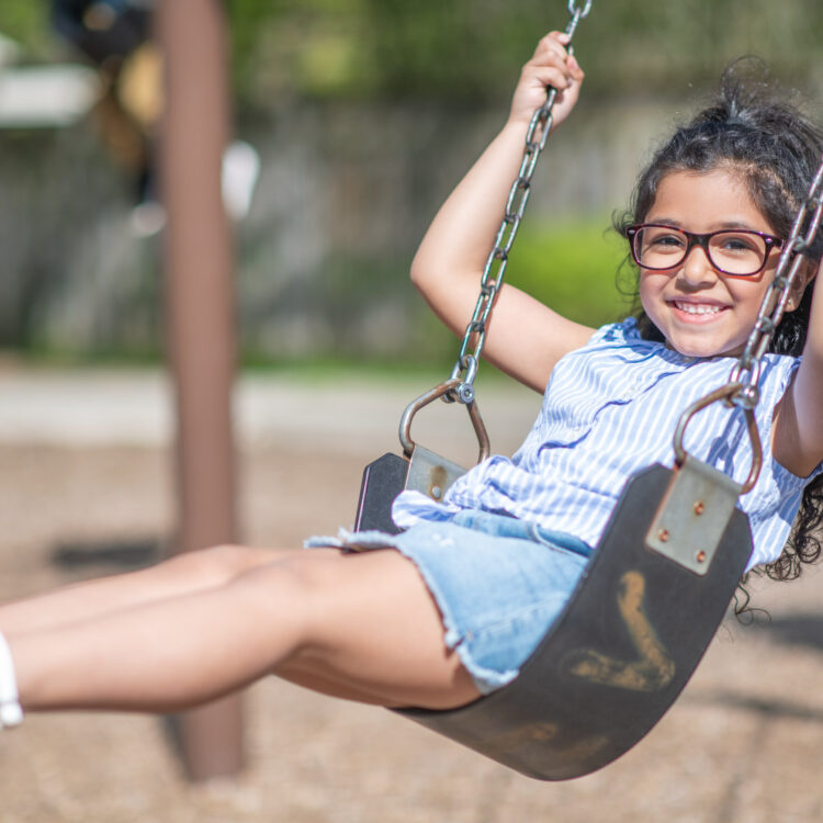 Girl showing off her smile at the playground, Tracy, CA